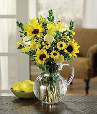 Sunflowers and yellow alstroemeria in pitcher