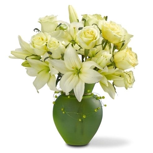 One dozen white roses with white lilies in a green vase