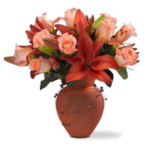 Orange roses and lilies delivered in a tangerine vase