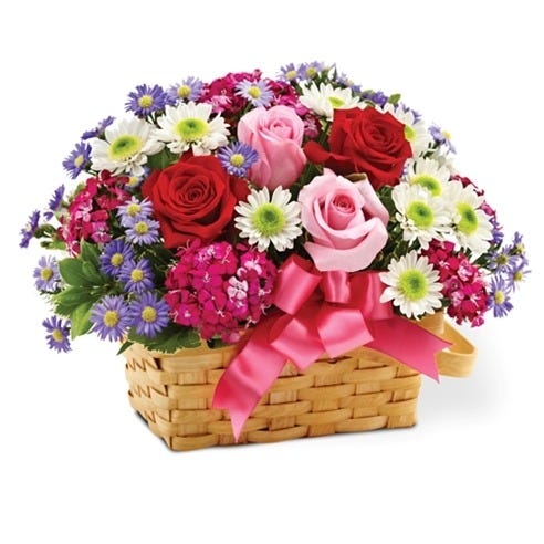 Red roses, pink roses and purple flowers delivered in a woven basket for Valentine