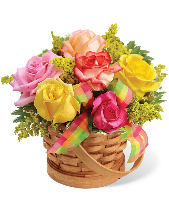 A Bouquet of Yellow, Peach, Coral And Pink Roses and Lush Greens in a Cute Basket with Decorative Ribbon