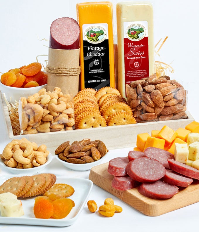 Summer Sausage 5 ounce, Sharp Cheddar Cheese 7 ounce, Harvest Vegetable Cheese 7 ounce,, Almonds 5 ounce,  Cashews 5 ounce, Dried Apricots 5 ounce, and Snack Crackers in a Gift Tray with Personalized Card Message