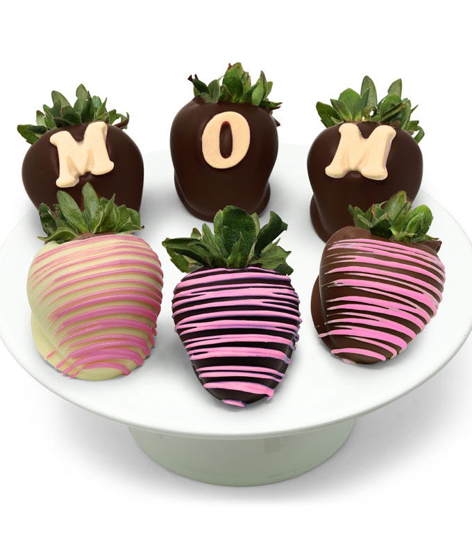 Elegant Mother's Day gift box of six Belgian chocolate-covered strawberries with pink drizzle and 'MOM' lettering on three strawberries.