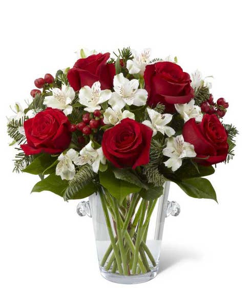 Red roses with white flowers in a modern vase for delivery this holiday
