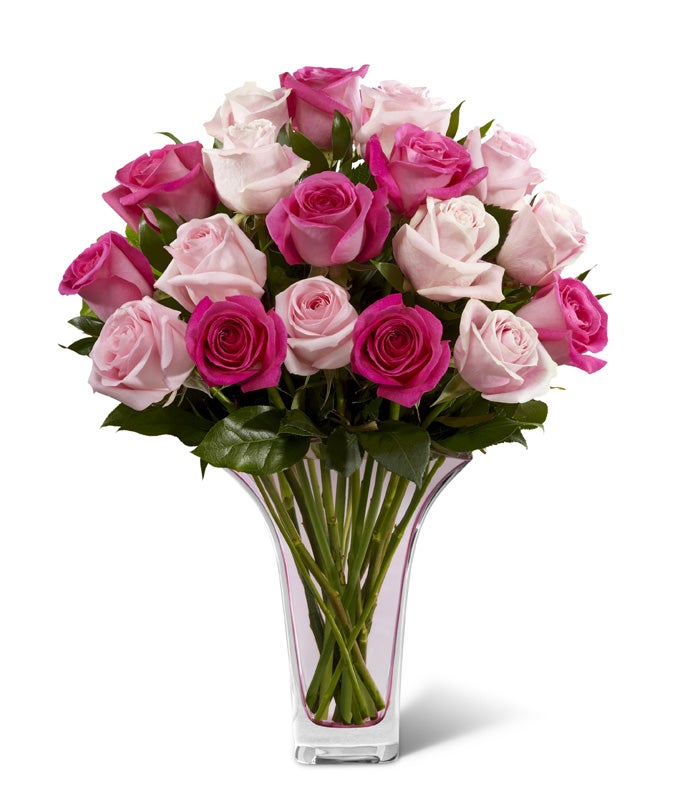 A Bouquet of Light-Pink Roses and Hot-Pink Roses in a Light Pink Glass Vase