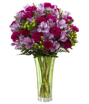 Purple Peruvian lily bouquet delivered in a tall clear glass vase