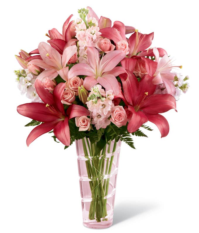 A Bouquet of Pink Spray Roses, Pink Stock, Pink and Dark Pink Asiatic Lilies in a Pale Pink Glass Vase