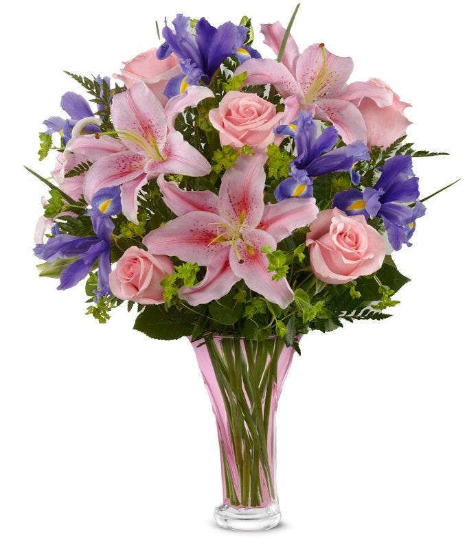 Sweetly elegant bouquet of pink roses, pink oriental lilies, blue irises, and lush greens