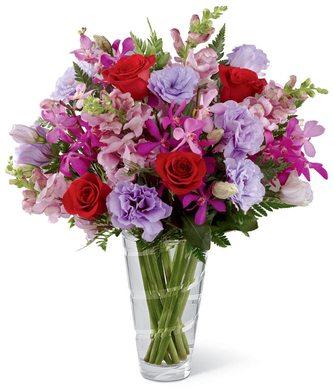 A Bouquet of Red Roses, Fuchsia Mokara Orchids, Lavender Lisianthus, Pink Snapdragon and Lush Greens in a Clear vase