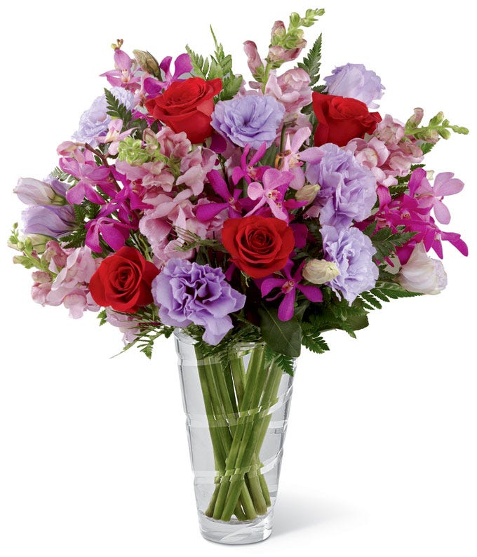 Vera Wang purple carnations, red roses and pink mokara orchid bouquet