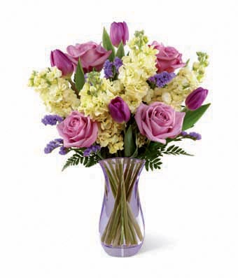 A Bouquet of Lavender Roses, Purple Tulips, Violet Statice and Pale Yellow Stock in a Designer Colorful Glass Vase