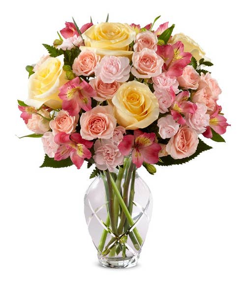 Coral flower bouquet delivery with yellow roses, pink carnations and peruvian lilies 