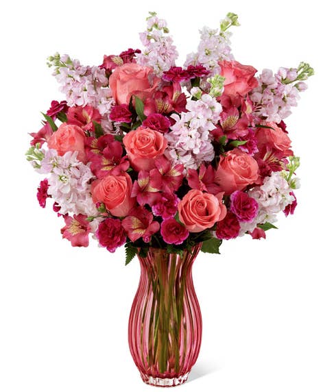 Coral flower bouquet with coral roses, fuchsia carnations, pink Peruvian lilies