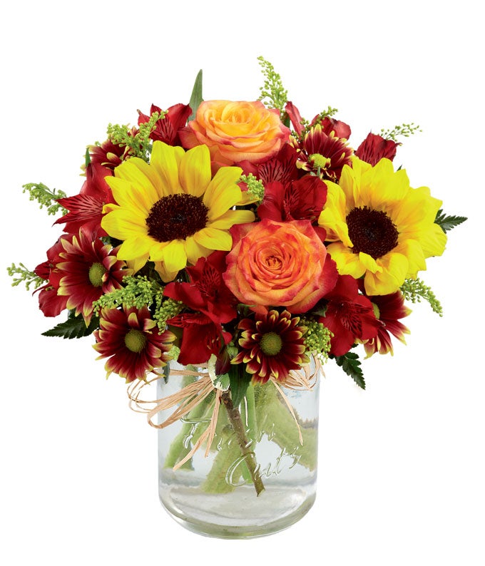 A Bouquet of Sunflowers, Orange Roses, Red Peruvian Lilies, Yellow Solidago, Burgundy Daisies and Lush Greens in a Mason Jar Vase