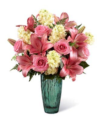 Pink lily and pink rose mixed flower bouquet with yellow stock in a sea-green vase
