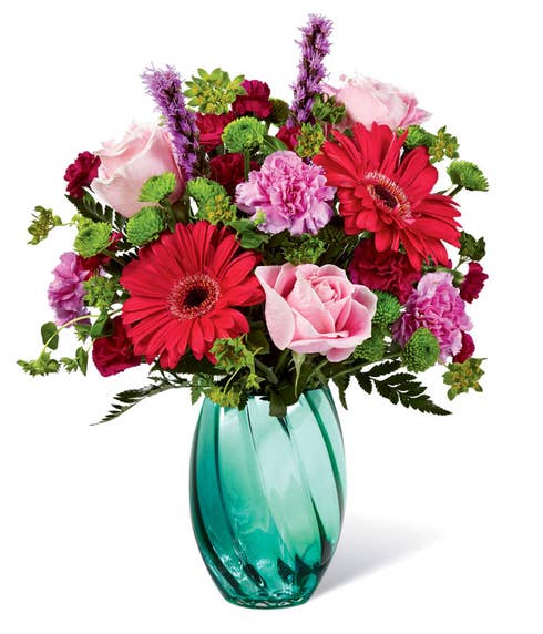 Pink gerbera daisies and roses with a variety of flowers