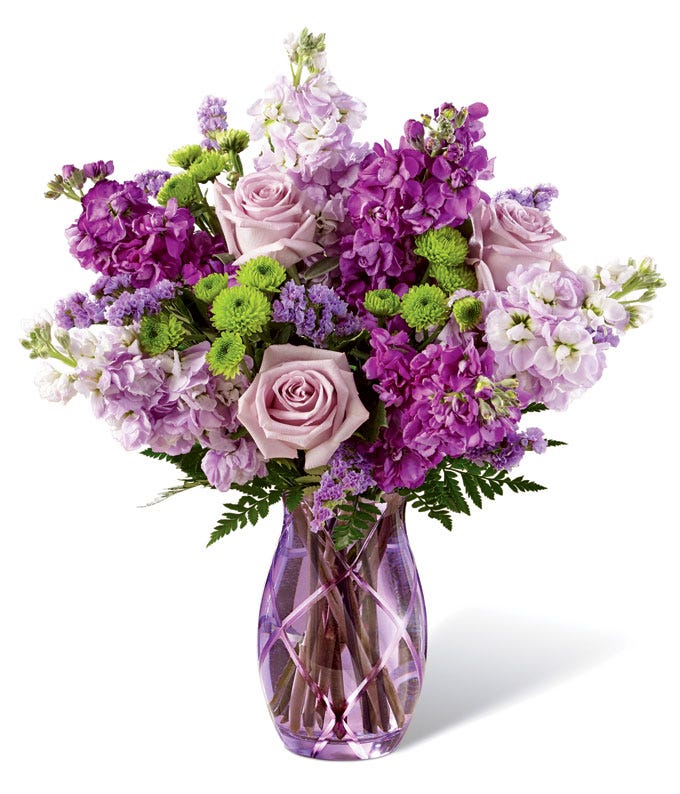 Purple flower bouquet with purple roses, lavender roses, purple stock flowers, and green mums