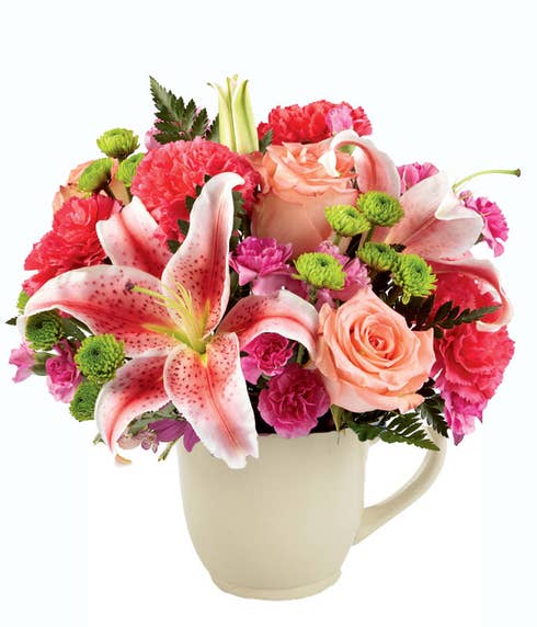 Stargazer lily cup bouquet with flowers in a cup with stargazer lily and coral roses