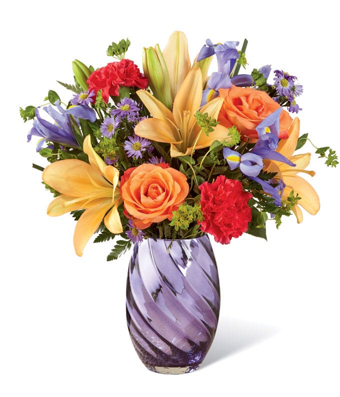 Peach lily and orange rose bouquet with blue iris and hot pink carnations