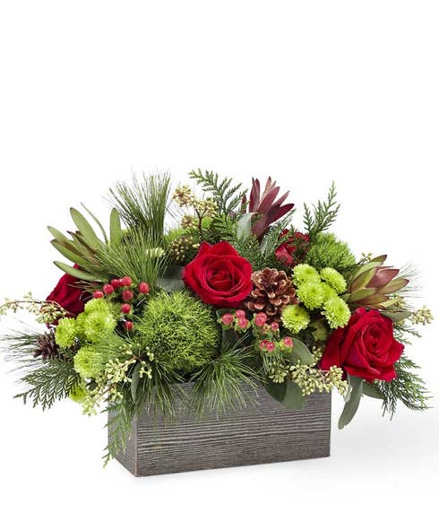 Winter greens centerpiece in wooden flower box arrangement of christmas flowers