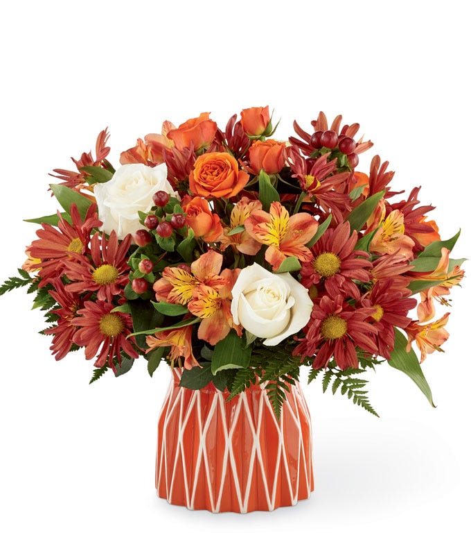 Fall flower arrangement with white and rose roses, red alstroemeria and maroon daisies