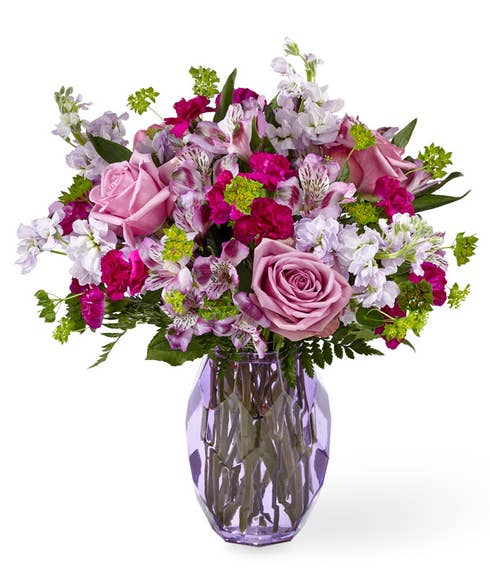 Lavender rose and alstroemeria flowers bouquet with lavender stock in purple vase