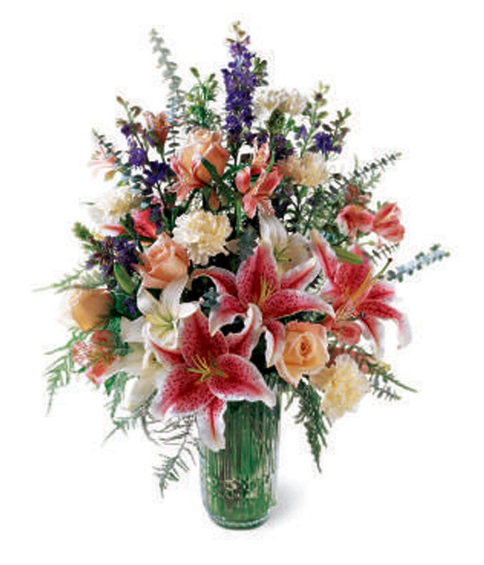 Luxury stargazer lily bouquet in green glass vase 