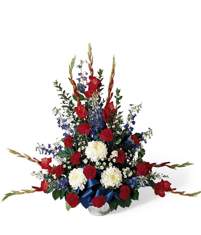 A Bouquet of Red Carnations, Blue Delphinium, Red Gladiolus, and White Mums in a Silver Toned Pot Cover