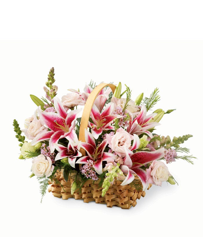 A Bouquet of Stargazer Lilies, Pink Double Lisianthus, Snapdragon, Pink Waxflower, Feathery Plumosa in a Braided Basket
