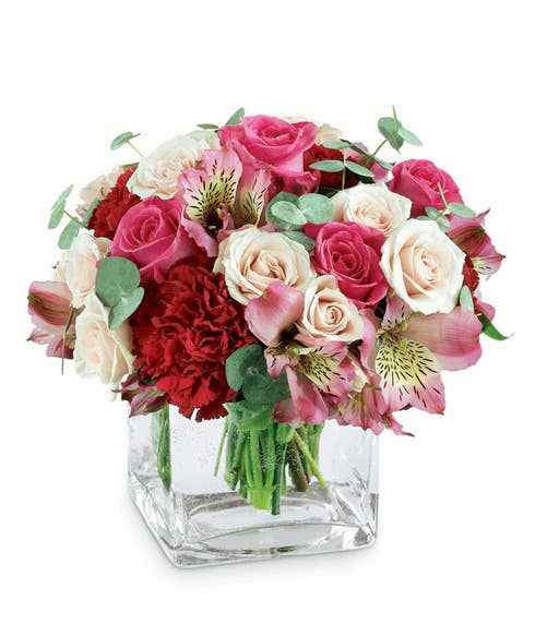 Romantic white roses, pink roses and red carnations in square glass vase 