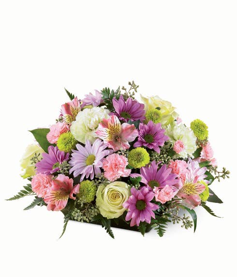 Sympathy pastel spring flowers arrangement with jade flowers, pink and green carnations