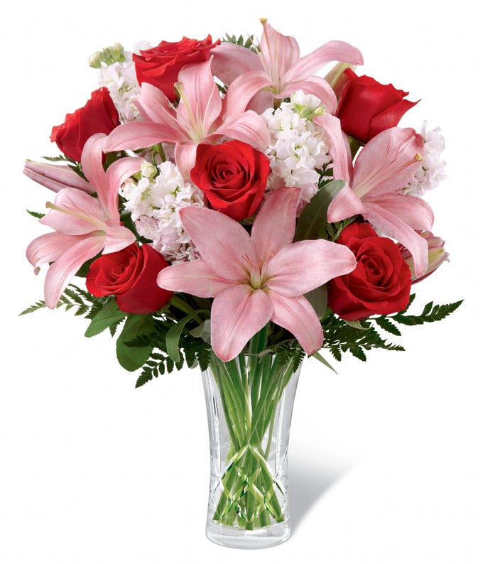 Pink lilies, red roses and white flowers