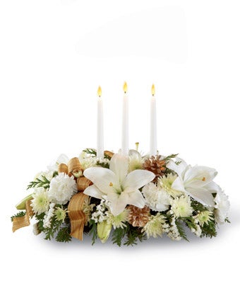 Centerpiece arrangement including White Lilies, White Carnations, and Chrysanthemums with Gold Pinecones and Tapered Candles