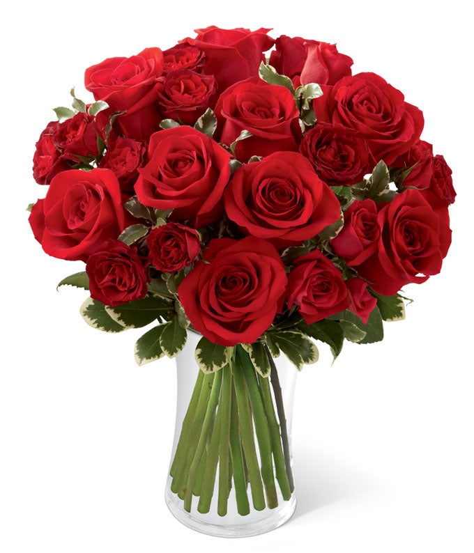 A Bouquet of Crimson Red Roses, Spray Roses, and Italian Variegated Pittosporum in a Glass Gathering Vase with Card Included