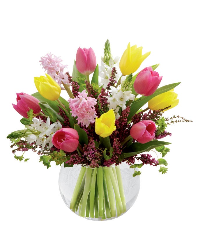 A Bouquet of Pink And Yellow Tulips, Blush Hyacinth, and White Star of Bethlehem Stems in a Clear Glass Round Vase with Card Message