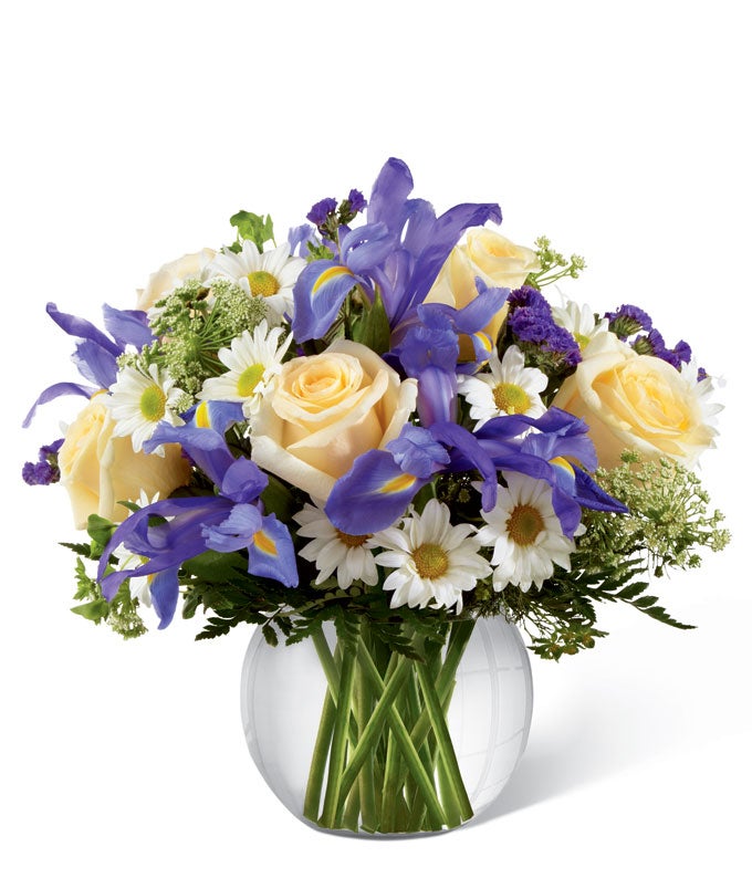 A Bouquet of Purple Iris, Yellow Roses, White Daisies, and Queen Anne's Lave in a Circular Glass Vase