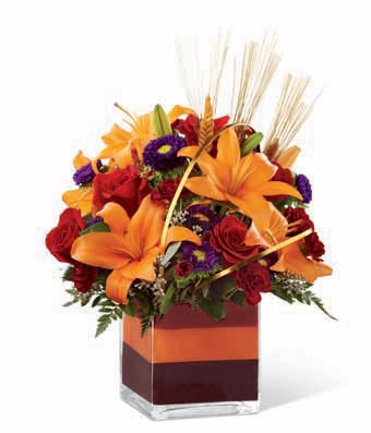 A Bouquet of Red Roses, Orange Asiatic Lilies, Burgundy Mini Carnations, Purple Matsumoto Asters and Lush Greens in a Clear Glass Cubed Vase