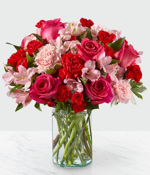 Hot pink roses, light pink carnations and hot pink carnations mixed spring bouquet
