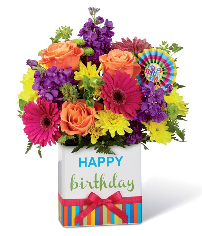 A Bouquet of Hot Pink Gerbera Daisies, Orange Roses, Purple Statice, and Yellow Pompoms with 