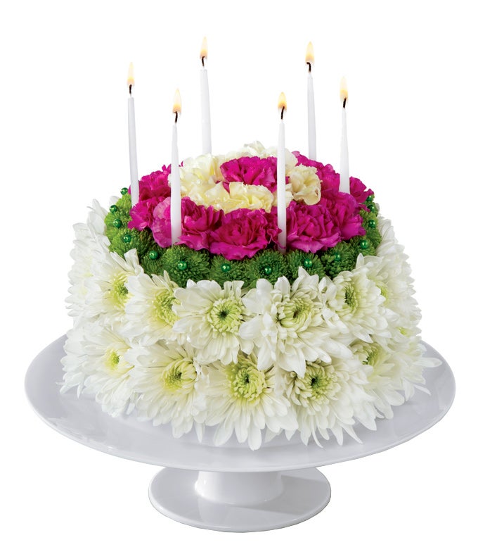 A Bouquet of White Chrysanthemums, Green Button Poms, Yellow Carnations, and Magenta Mini Carnations form as a whole cake that Comes in a Platter For Cakes
