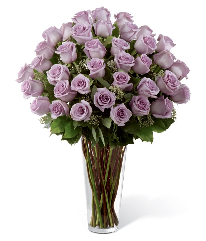 A Bouquet of Lavender Roses and Seeded Eucalyptus in a Clear Glass Vase