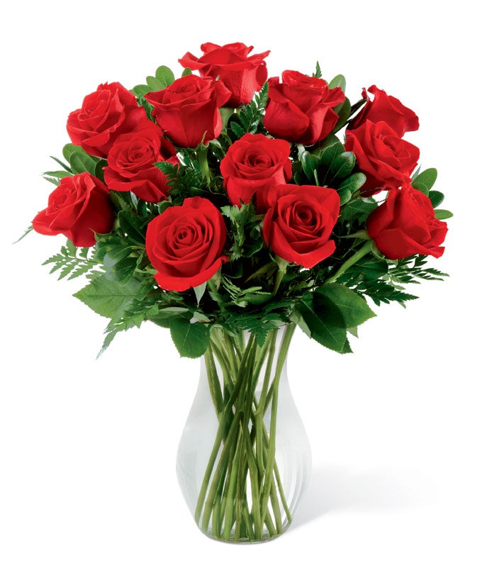 A Bouquet of 24 Red Pieces Rose Stems and Fresh Cut Greenery in a Clear Glass Vase