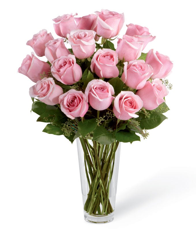 A Bouquet of Pink Roses, and Seeded Eucalyptus in a Clear Glass Vase