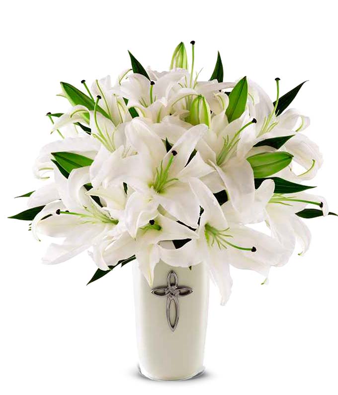 White lilies delivered in a vase decorated with a silver cross