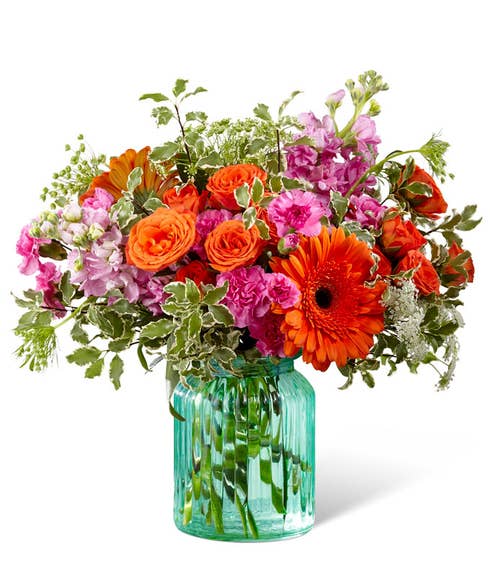 Tropical mixed flower bouquet with Orange gerbera daisies and pink carnations 