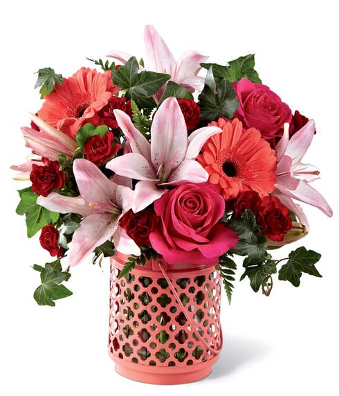 Coral daisy, pink lily, and pink and red rose bouquet 