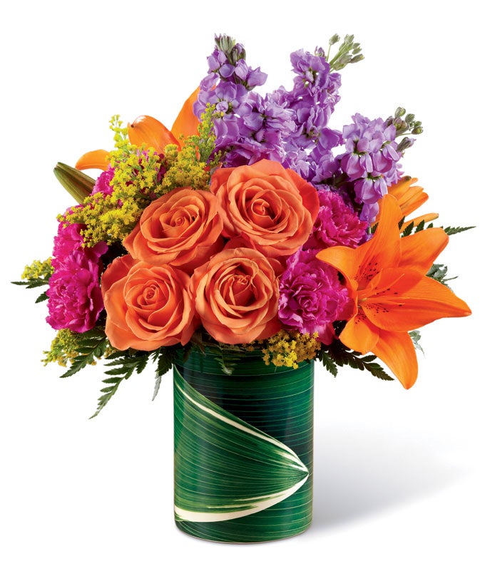 A Bouquet of Orange Roses, Orange Lilies, Pink Carnations and Purple Stock in a Faux Green Leaf Vase
