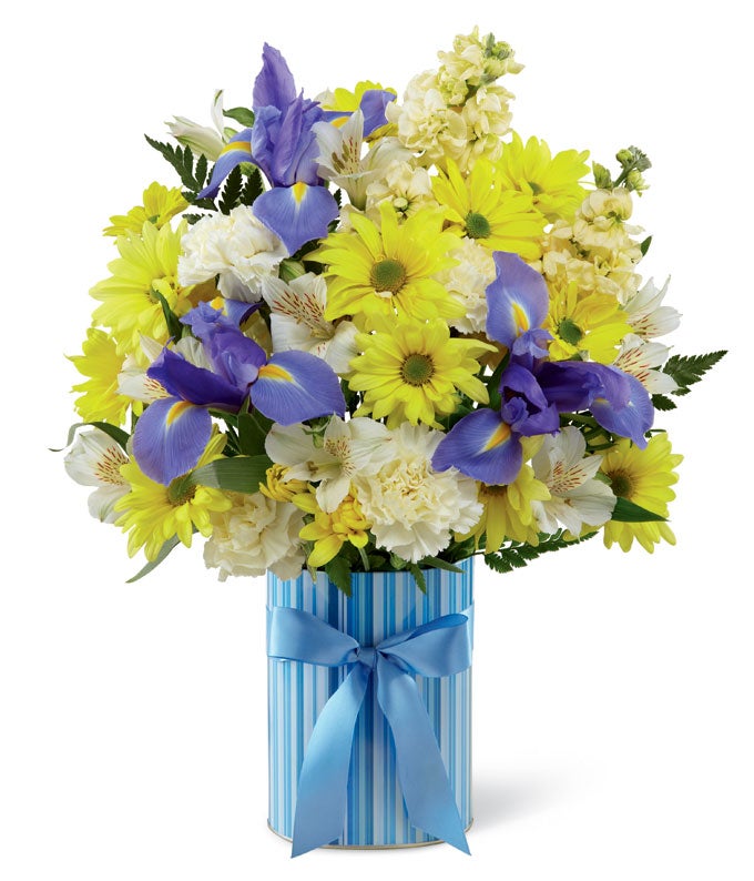 A Bouquet of Blue Iris, Yellow Traditional Daisies, White Peruvian Lilies and Yellow Stock in a Decorative Blue Vase with Satin Ribbon