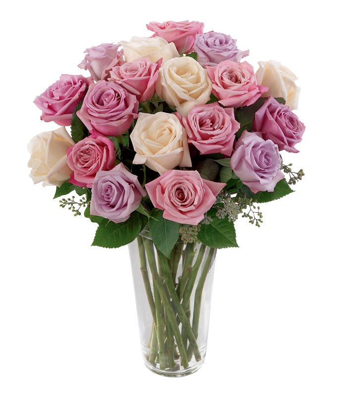 A Bouquet of Long-Stem Pale Pink, Cream, And Lavender Roses in a Clear Glass Vase