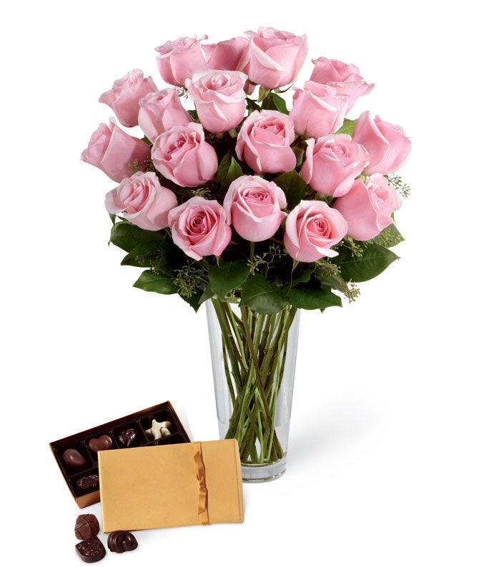 A Bouquet of Pale Pink Roses, Seeded Eucalyptus and Lush Greens in a Clear Glass Vase with Godiva Luxury Chocolates